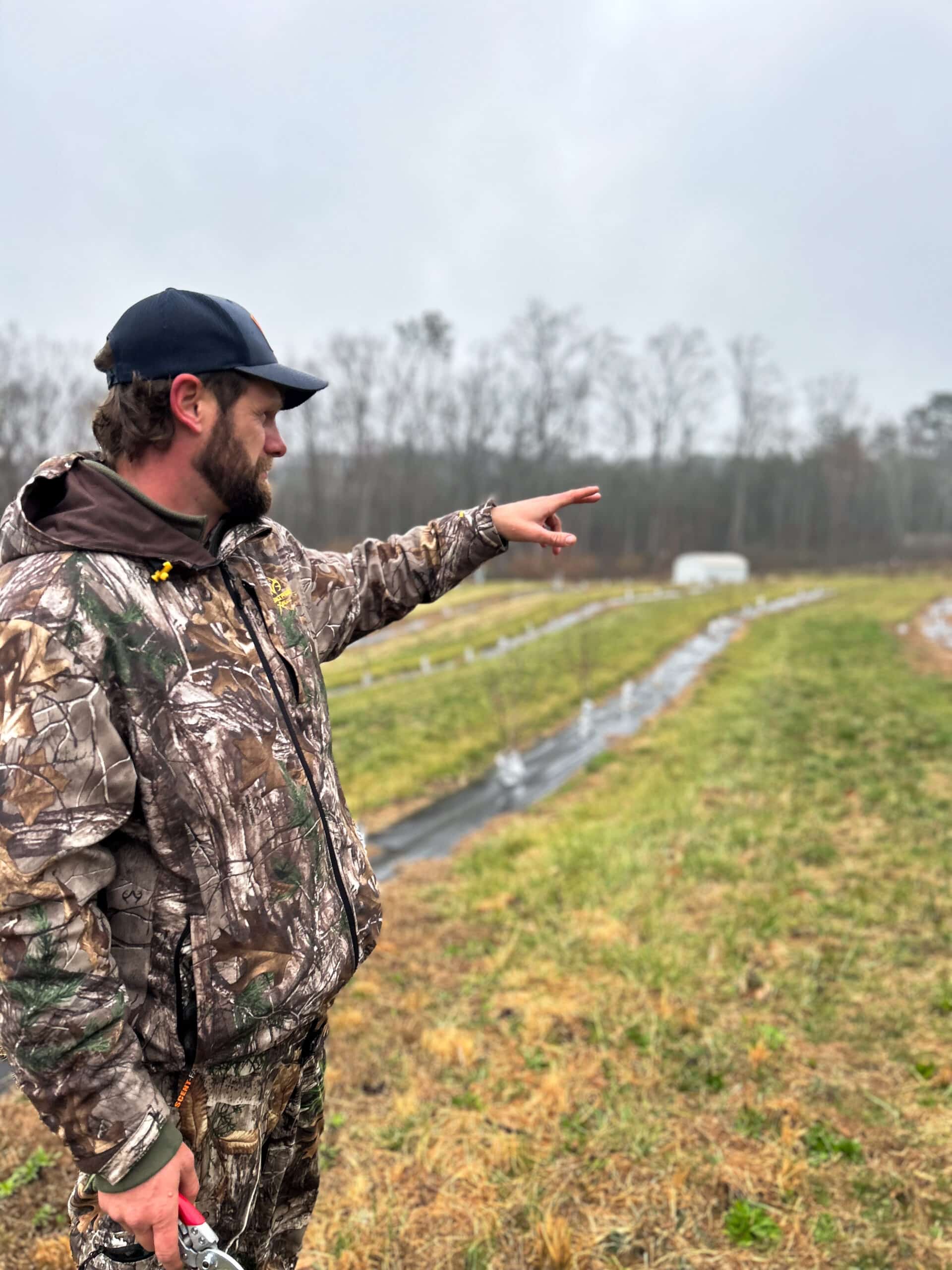 Blake Price showing his land at Athens Orchard